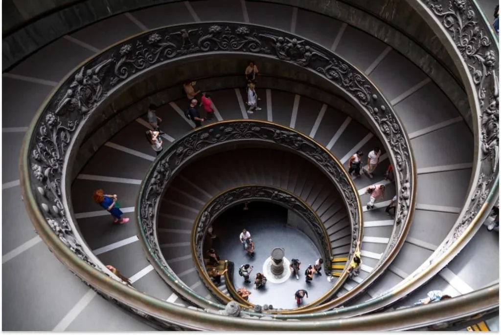 people on the stairs of the vatican museum